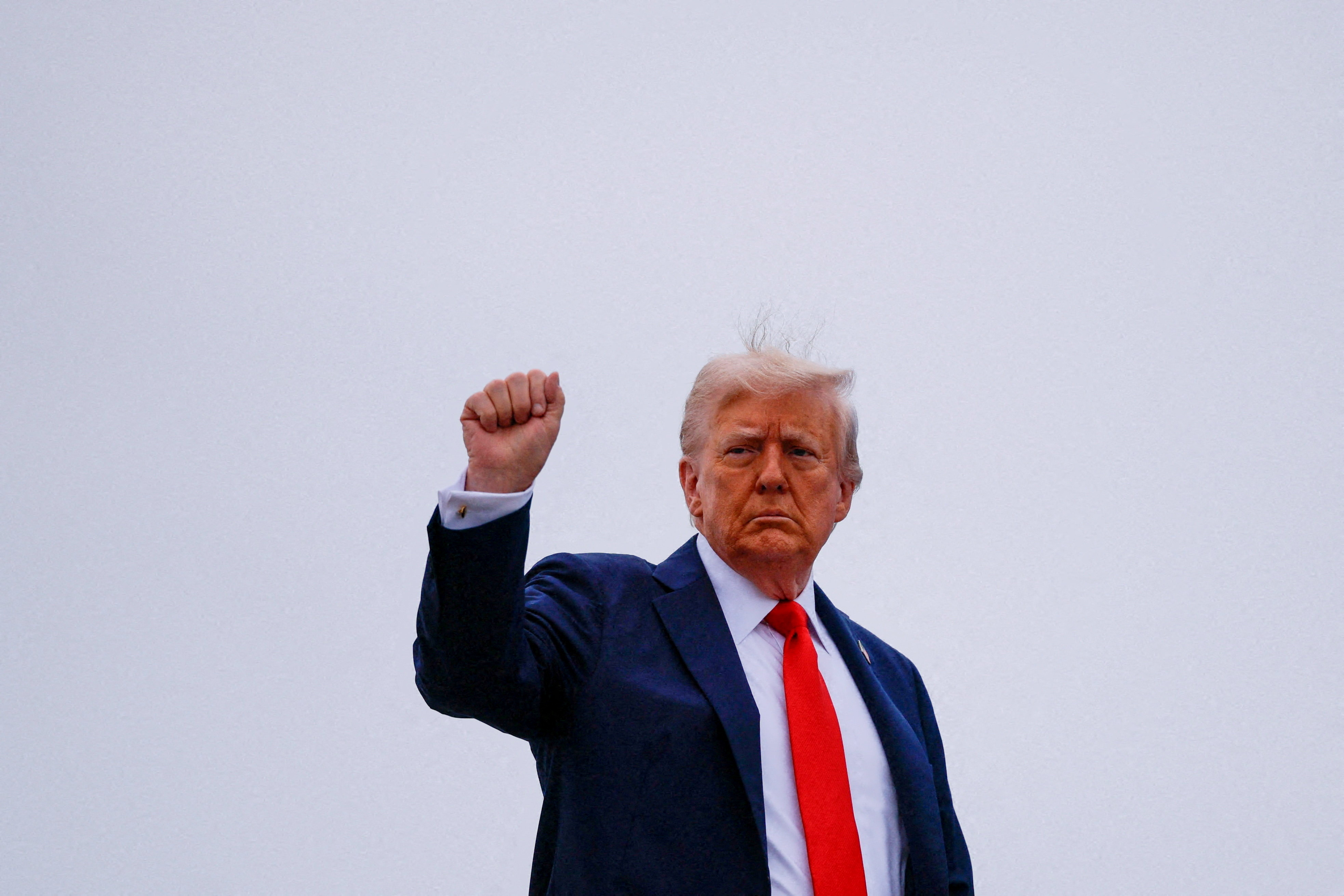 US President Donald Trump gestures, as he boards Air Force One to depart for a memorial service for slain conservative commentator Charlie Kirk, at Joint Base Andrews, Maryland, US (Reuters)